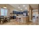 Eat in kitchen features quartz countertops, stainless steel appliances and barstool seating at the island at 522 S 122Nd Ln, Avondale, AZ 85323