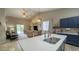 Bright kitchen features quartz countertops, stainless steel appliances and barstool seating at the island at 522 S 122Nd Ln, Avondale, AZ 85323
