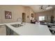 The kitchen features granite countertops, stainless steel sink, and an open layout to the living area at 522 S 122Nd Ln, Avondale, AZ 85323