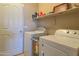 Convenient laundry room with washer, dryer, and storage shelves, making chores a breeze at 522 S 122Nd Ln, Avondale, AZ 85323