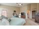 Spacious main bedroom boasts a walk-in closet, light blue comforter, and ceiling fan, a relaxing retreat at 522 S 122Nd Ln, Avondale, AZ 85323