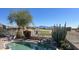 Backyard pool with view of the golf course, mountains, and desert landscaping, creating a tranquil oasis at 522 S 122Nd Ln, Avondale, AZ 85323