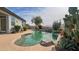 Backyard swimming pool with desert landscaping, rock waterfall feature, and patio seating at 522 S 122Nd Ln, Avondale, AZ 85323