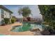 Backyard pool with desert landscaping, rock waterfall feature, and patio seating area at 522 S 122Nd Ln, Avondale, AZ 85323