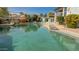 Backyard pool with clear water, rock features, and landscaping, and patio seating at 522 S 122Nd Ln, Avondale, AZ 85323