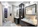 Stylish bathroom with dual sinks, sleek black cabinetry, and decorative accents at 5532 W Onyx Ave, Glendale, AZ 85302