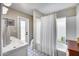 Well-lit bathroom with stylish blue patterned tile floors and shower-tub combo with curtain at 5532 W Onyx Ave, Glendale, AZ 85302