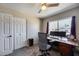 Functional bedroom with a desk setup, large windows, and a spacious closet at 5532 W Onyx Ave, Glendale, AZ 85302