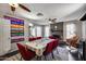Bright dining area with a stone fireplace, ceiling fans, and game table with red chairs at 5532 W Onyx Ave, Glendale, AZ 85302