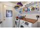 Well-organized laundry room with washer, dryer, shelving, and laminate countertop at 5532 W Onyx Ave, Glendale, AZ 85302