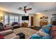 Inviting living room with dark hardwood floors, bay window, a ceiling fan, and multiple seating areas at 5532 W Onyx Ave, Glendale, AZ 85302