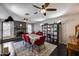 Spacious living area with fireplace, game table, red chairs, and custom game storage at 5532 W Onyx Ave, Glendale, AZ 85302