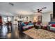 Spacious living room with dark hardwood floors and an open concept to kitchen and dining area at 5532 W Onyx Ave, Glendale, AZ 85302
