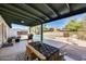 Covered patio with table overlooks the refreshing pool and backyard, perfect for outdoor entertaining at 5532 W Onyx Ave, Glendale, AZ 85302