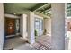 Inviting covered porch with decorative columns, beautiful wood door with ring, and brick paver accents at 5532 W Onyx Ave, Glendale, AZ 85302