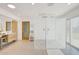 Bright bathroom featuring a glass shower, modern vanity, and neutral tile at 6071 E Ludlow Dr, Scottsdale, AZ 85254