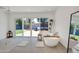 Bright bathroom featuring a freestanding tub, potted plant, and a sliding glass door to the backyard at 6071 E Ludlow Dr, Scottsdale, AZ 85254