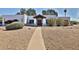 Charming single-story home featuring a well-manicured desert landscape, a bright white exterior, and a welcoming entrance at 6071 E Ludlow Dr, Scottsdale, AZ 85254