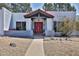 Beautiful home exterior with desert landscaping, and a decorative front door featuring a cactus design and overhead gable at 6071 E Ludlow Dr, Scottsdale, AZ 85254