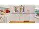 Modern kitchen offers white cabinets and countertops, a stainless dishwasher, and view of private pool at 6071 E Ludlow Dr, Scottsdale, AZ 85254
