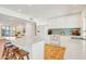Modern eat-in kitchen boasts terracotta floors, central island with stool seating, and stainless appliances at 6071 E Ludlow Dr, Scottsdale, AZ 85254