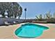 Backyard pool with a built-in bar and mature landscaping at 6071 E Ludlow Dr, Scottsdale, AZ 85254