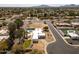 An aerial shot displays the house, pool, neighborhood, nearby street and an expansive view of the community at 6071 E Ludlow E Dr, Scottsdale, AZ 85254