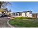 Expansive backyard with green lawn, patio, and privacy wall is great for outdoor living and entertaining at 6071 E Ludlow E Dr, Scottsdale, AZ 85254