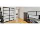Bright bedroom with sliding door closet, light wood floors, ladder, and an open door leading to a bedroom at 6071 E Ludlow Dr, Scottsdale, AZ 85254