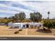 Charming home featuring a red roof, a gravel yard, desert landscaping, and a quaint walkway leading to the front door at 6071 E Ludlow Dr, Scottsdale, AZ 85254