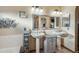 Well-lit bathroom featuring dual sinks, a large mirror, and decorative elements at 644 W Dublin St, Gilbert, AZ 85233