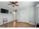 Neutral-toned bedroom featuring hardwood floors, closet, TV and two entry doors at 644 W Dublin St, Gilbert, AZ 85233