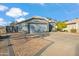Charming single-story home showcasing a gray facade, desert landscaping, and a two-car garage at 644 W Dublin St, Gilbert, AZ 85233