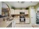 Bright kitchen with stainless steel appliances, neutral countertops, and white cabinets at 644 W Dublin St, Gilbert, AZ 85233