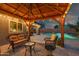 Covered patio area with comfortable seating, overlooking the sparkling pool at 644 W Dublin St, Gilbert, AZ 85233