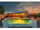 Backyard features a sparkling pool with a covered outdoor kitchen and seating at 644 W Dublin St, Gilbert, AZ 85233