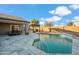 Inviting backyard pool area with a lounge, built-in water feature and gray tile decking at 644 W Dublin St, Gilbert, AZ 85233