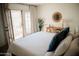 Tranquil bedroom with a decorative mirror and private patio access at 7023 E 4Th St # 104, Scottsdale, AZ 85251