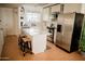 Modern white kitchen with stainless steel appliances and a spacious island at 7023 E 4Th St # 104, Scottsdale, AZ 85251