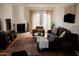Inviting living room featuring a cozy fireplace and ample natural light at 7023 E 4Th St # 104, Scottsdale, AZ 85251