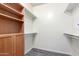 Spacious walk-in closet features custom shelving, drawers and hanging racks for optimal storage solutions at 705 W Queen Creek Rd # 1220, Chandler, AZ 85248