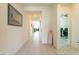 Hallway showcasing tile floors, neutral paint and access to the living area and office space at 7201 E Aerie Way, San Tan Valley, AZ 85143