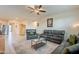 Spacious living room featuring leather sofas, ceiling fan, and neutral décor at 7201 E Aerie Way, San Tan Valley, AZ 85143