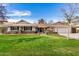 Charming single-story home featuring lush green lawn, brick accents, and a well-manicured front yard at 7744 N 6Th St, Phoenix, AZ 85020