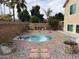 Well-maintained backyard featuring a circular pool surrounded by brick pavers and landscaping, offering a private retreat at 807 E Harvard Ave, Gilbert, AZ 85234