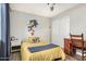 A cozy bedroom with a yellow bed, Sonic the Hedgehog wall decor, and a vintage wooden desk at 807 E Harvard Ave, Gilbert, AZ 85234