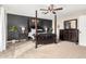 The primary bedroom showcases a four-poster bed, dark accent wall, and elegant matching dresser at 807 E Harvard Ave, Gilbert, AZ 85234