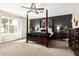 This primary bedroom offers a four-poster bed, dark accent wall, and a ceiling fan at 807 E Harvard Ave, Gilbert, AZ 85234