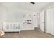 Bedroom room with white crib, decor shelf, and carpet flooring at 807 E Harvard Ave, Gilbert, AZ 85234