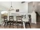 Dining room with a rustic table, decorative lighting, and an open view to the living spaces at 807 E Harvard Ave, Gilbert, AZ 85234